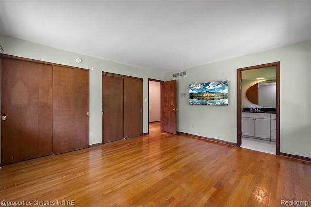 30700 Marimoor St, Beverly Hills, MI 48025 - unfurnished bedroom with two closets, light wood-style floors, and ensuite bath
