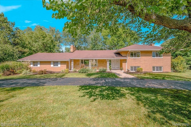 30700 Marimoor St, Beverly Hills, MI 48025 - split level home with a chimney, a front yard, and brick siding