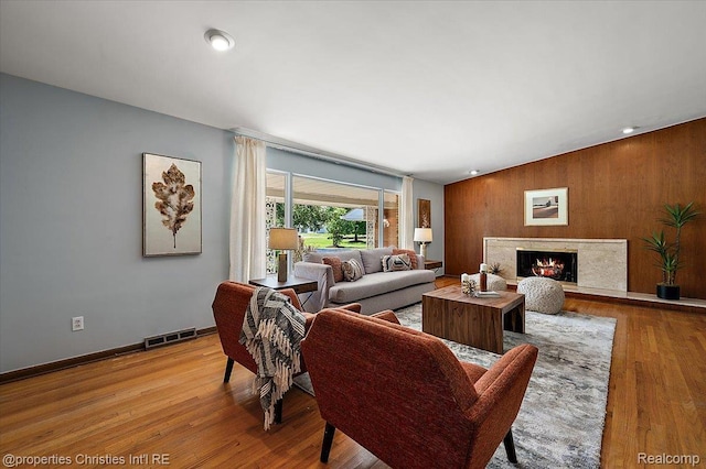 30700 Marimoor St, Beverly Hills, MI 48025 - living area featuring wood finished floors, wood walls, and a high end fireplace