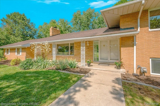 30700 Marimoor St, Beverly Hills, MI 48025 - view of front of home featuring a chimney, a front lawn, brick siding, and a porch