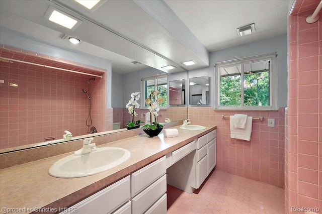 30700 Marimoor St, Beverly Hills, MI 48025 - bathroom with tile walls, double vanity, a tile shower, and tile patterned floors