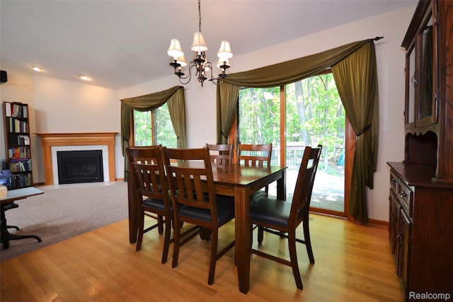 10010 Orchard Ridge Ct, Holly, MI 48442 - dining space featuring light wood-style flooring, a chandelier, and a tile fireplace