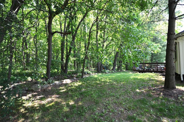 10010 Orchard Ridge Ct, Holly, MI 48442 - view of yard with a wooden deck and a wooded view