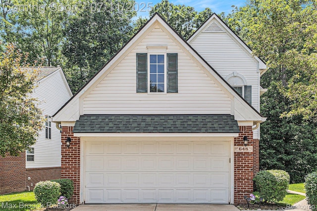 648SHADYMAPLE Shady Maple Dr Unit 16, Wixom, MI 48393 - view of front of house featuring brick siding, driveway, and a shingled roof