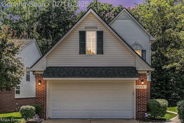 648SHADYMAPLE Shady Maple Dr Unit 16, Wixom, MI 48393 - traditional-style house with brick siding, driveway, and roof with shingles