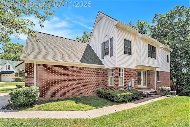 648SHADYMAPLE Shady Maple Dr Unit 16, Wixom, MI 48393 - view of front facade featuring brick siding, a front lawn, and a shingled roof