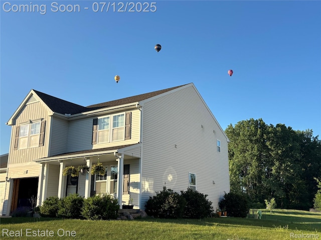 750 Dewars St, Howell, MI 48843 - view of front facade with a front yard and covered porch