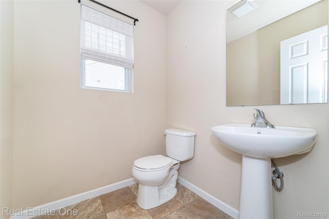 750 Dewars St, Howell, MI 48843 - bathroom with toilet and baseboards