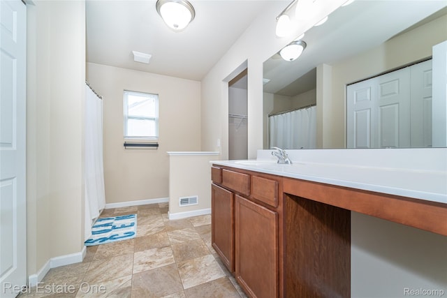 750 Dewars St, Howell, MI 48843 - bathroom with vanity, a closet, and stone finish flooring