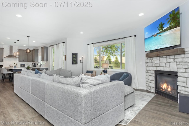460 Lake Manitou Trl, Oxford, MI 48371 - living area with a fireplace, recessed lighting, and light wood-style floors