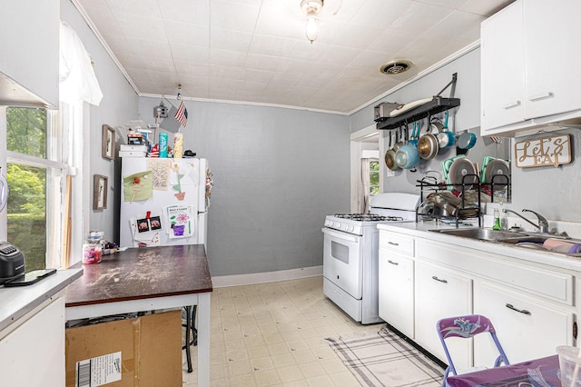 1638 Cherry St, Niles, MI 49120 - kitchen with white appliances, crown molding, white cabinetry, and light flooring
