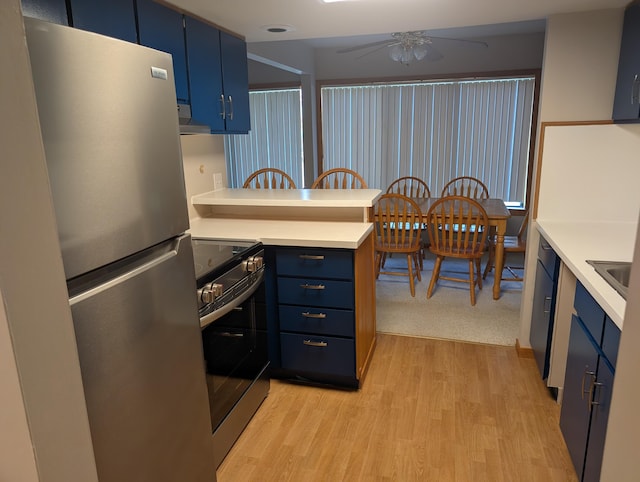 149 Selkirk Ct Unit A, Kalamazoo, MI 49006 - kitchen featuring stainless steel appliances, blue cabinetry, a ceiling fan, light countertops, and light wood finished floors
