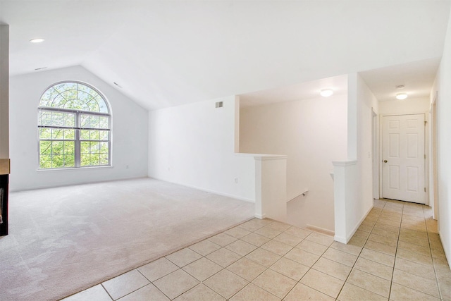 3132 Primrose Ln, Ypsilanti, MI 48197 - unfurnished living room featuring light colored carpet, light tile patterned floors, and lofted ceiling