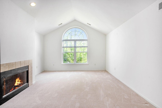 3132 Primrose Ln, Ypsilanti, MI 48197 - unfurnished living room with a tiled fireplace, vaulted ceiling, and carpet floors