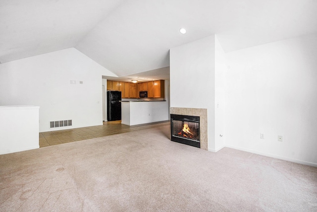3132 Primrose Ln, Ypsilanti, MI 48197 - unfurnished living room featuring light colored carpet, a fireplace, and lofted ceiling