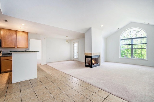 3132 Primrose Ln, Ypsilanti, MI 48197 - unfurnished living room featuring light colored carpet, light tile patterned flooring, vaulted ceiling, a multi sided fireplace, and recessed lighting