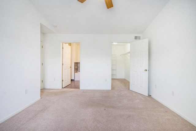 3132 Primrose Ln, Ypsilanti, MI 48197 - unfurnished bedroom with carpet floors, a walk in closet, ensuite bath, and a ceiling fan