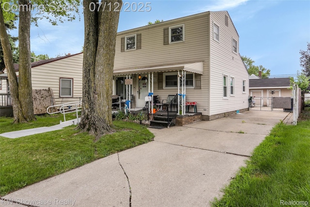 4313 S Dearborn St, Melvindale, MI 48122 - view of front of property featuring a porch, concrete driveway, and a gate