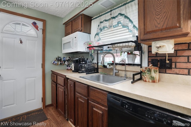 4313 S Dearborn St, Melvindale, MI 48122 - kitchen with dishwasher, white microwave, light countertops, dark wood-type flooring, and a textured ceiling