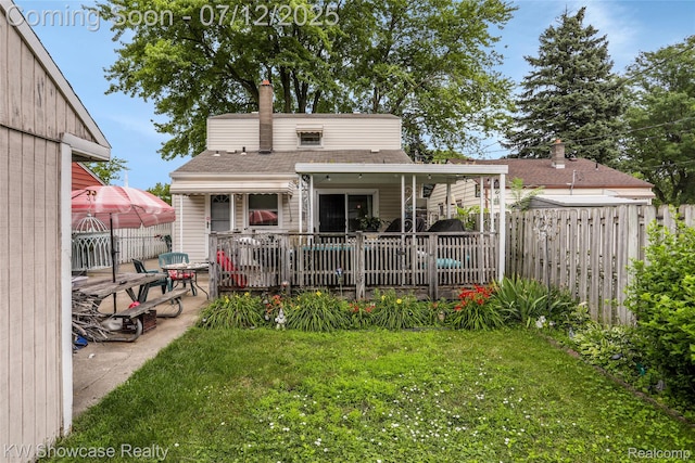 4313 S Dearborn St, Melvindale, MI 48122 - back of property with a chimney, a shingled roof, and a patio