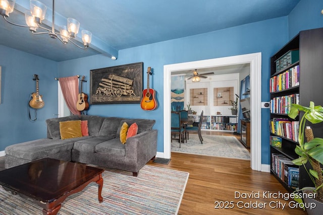 122 Dwight Ave SE, Grand Rapids, MI 49506 - living area featuring a chandelier, wood finished floors, ceiling fan, and beam ceiling