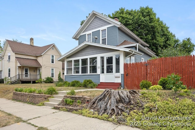 122 Dwight Ave SE, Grand Rapids, MI 49506 - view of front of house featuring a sunroom and a chimney