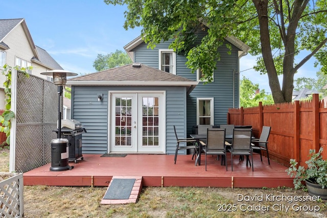 122 Dwight Ave SE, Grand Rapids, MI 49506 - rear view of property featuring french doors, a wooden deck, outdoor dining space, and roof with shingles