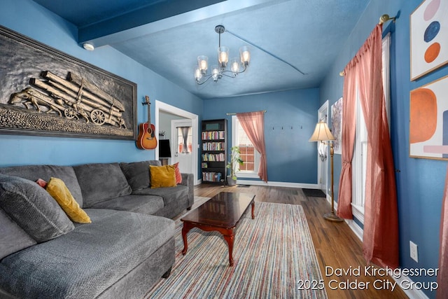 122 Dwight Ave SE, Grand Rapids, MI 49506 - living room featuring wood finished floors, a chandelier, and beamed ceiling
