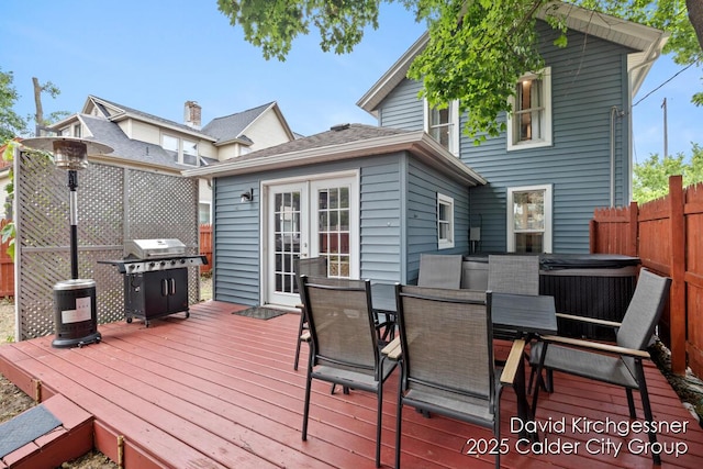122 Dwight Ave SE, Grand Rapids, MI 49506 - wooden terrace with a hot tub, french doors, area for grilling, and outdoor dining area