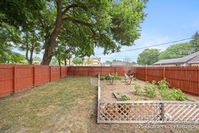122 Dwight Ave SE, Grand Rapids, MI 49506 - fenced backyard with a vegetable garden