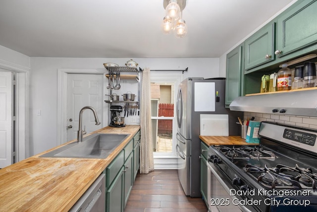 122 Dwight Ave SE, Grand Rapids, MI 49506 - kitchen featuring stainless steel gas range oven, green cabinets, butcher block counters, open shelves, and decorative backsplash