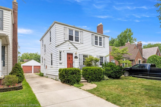 711 N Highland St, Dearborn, MI 48128 - view of front of home with a front lawn, a garage, a chimney, and an outdoor structure