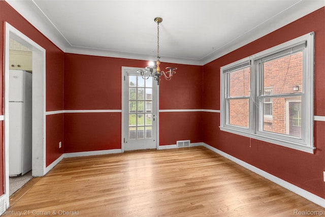 711 N Highland St, Dearborn, MI 48128 - unfurnished dining area with light wood-style floors and a chandelier