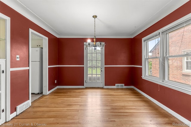 711 N Highland St, Dearborn, MI 48128 - unfurnished dining area featuring a chandelier and light wood finished floors