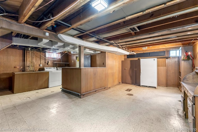 711 N Highland St, Dearborn, MI 48128 - below grade area featuring wood walls, light floors, and washing machine and dryer