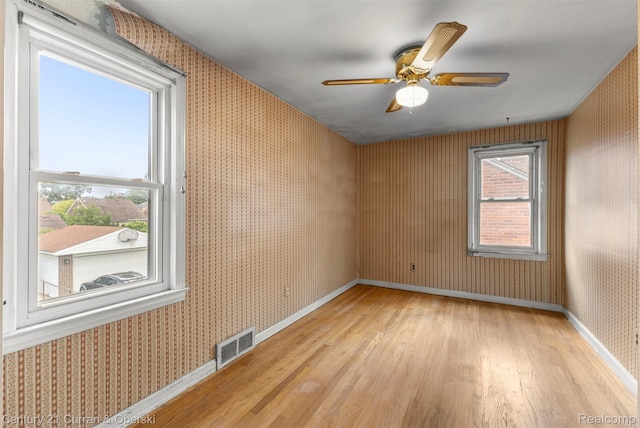 711 N Highland St, Dearborn, MI 48128 - spare room with wallpapered walls, light wood-style flooring, and a ceiling fan
