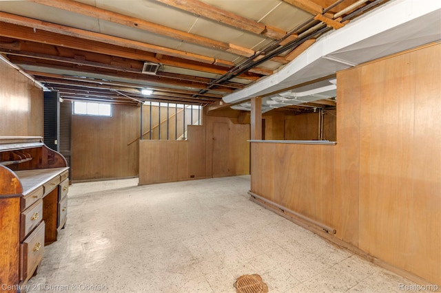 711 N Highland St, Dearborn, MI 48128 - below grade area featuring stairway, light flooring, and wooden walls