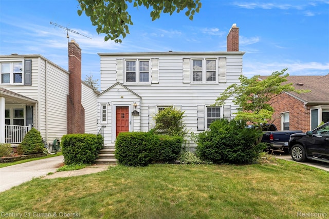 711 N Highland St, Dearborn, MI 48128 - view of front facade with a front yard and a chimney