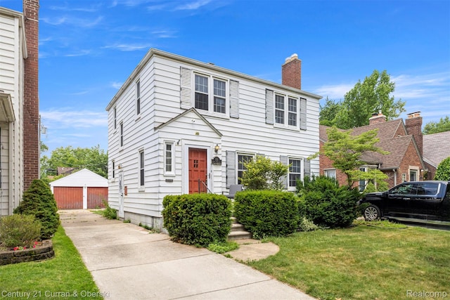 711 N Highland St, Dearborn, MI 48128 - colonial house with a front lawn, a chimney, an outbuilding, and a garage