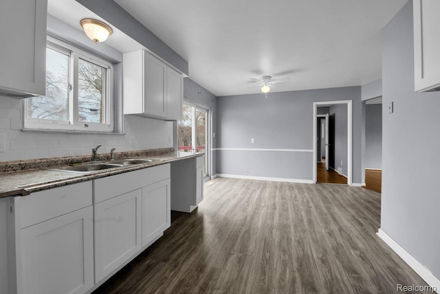 3217 Donna Ave, Warren, MI 48091 - kitchen featuring a ceiling fan, white cabinetry, tasteful backsplash, and dark wood finished floors
