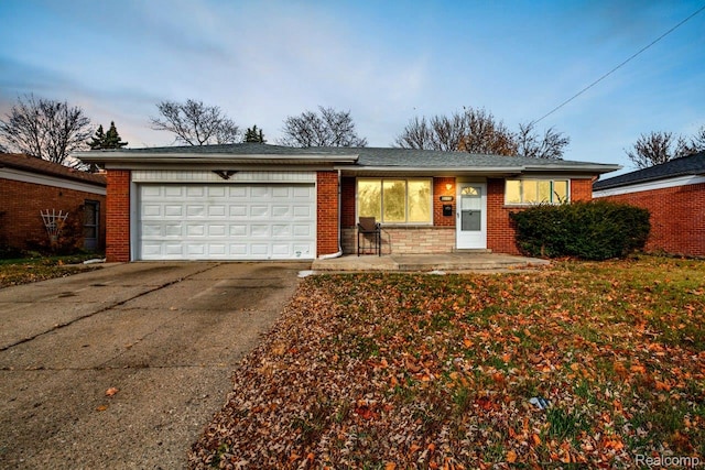 3217 Donna Ave, Warren, MI 48091 - ranch-style home with concrete driveway, a garage, and brick siding