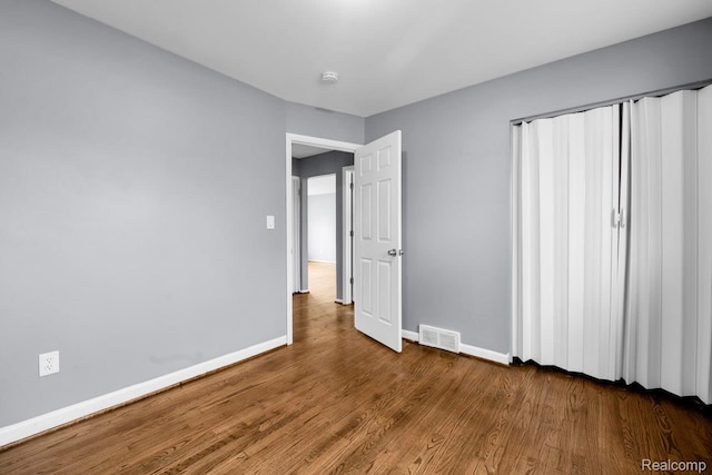 3217 Donna Ave, Warren, MI 48091 - unfurnished bedroom with wood finished floors and baseboards