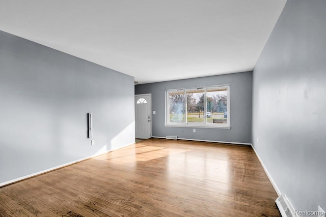 3217 Donna Ave, Warren, MI 48091 - unfurnished living room featuring wood finished floors and baseboards
