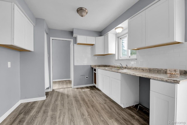 3217 Donna Ave, Warren, MI 48091 - kitchen featuring wood finished floors, white cabinetry, decorative backsplash, and light stone countertops