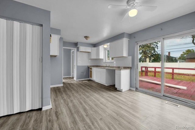 3217 Donna Ave, Warren, MI 48091 - kitchen featuring white cabinetry, a ceiling fan, and light wood-style floors