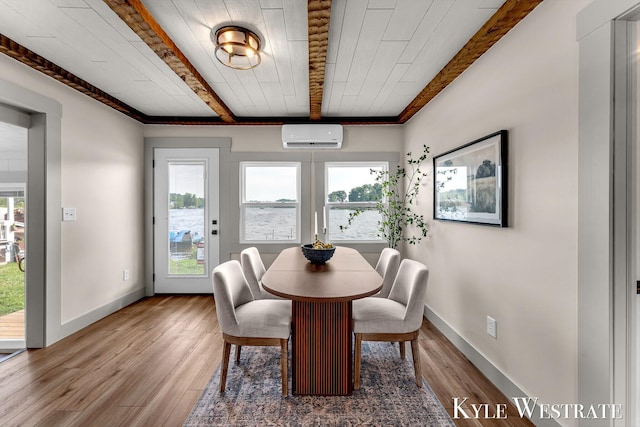 12230 Mac Dr NE, Belding, MI 48809 - dining room featuring a wall mounted air conditioner, plenty of natural light, wood finished floors, a wood ceiling with exposed beams, and a water view