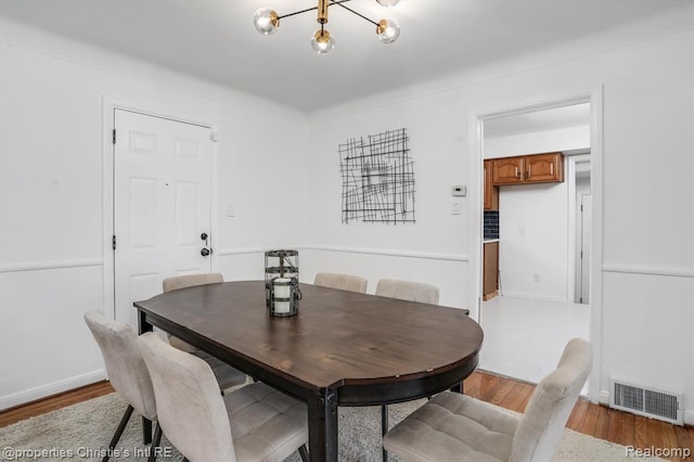 17617 Kentucky St, Detroit, MI 48221 - dining area featuring wood finished floors and a chandelier