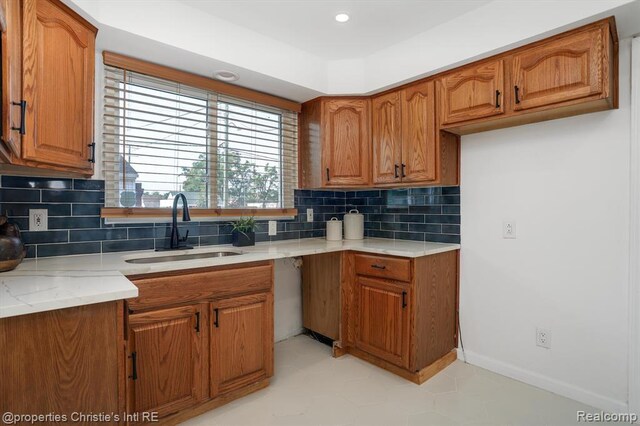 17617 Kentucky St, Detroit, MI 48221 - kitchen with brown cabinetry, decorative backsplash, light stone countertops, and recessed lighting
