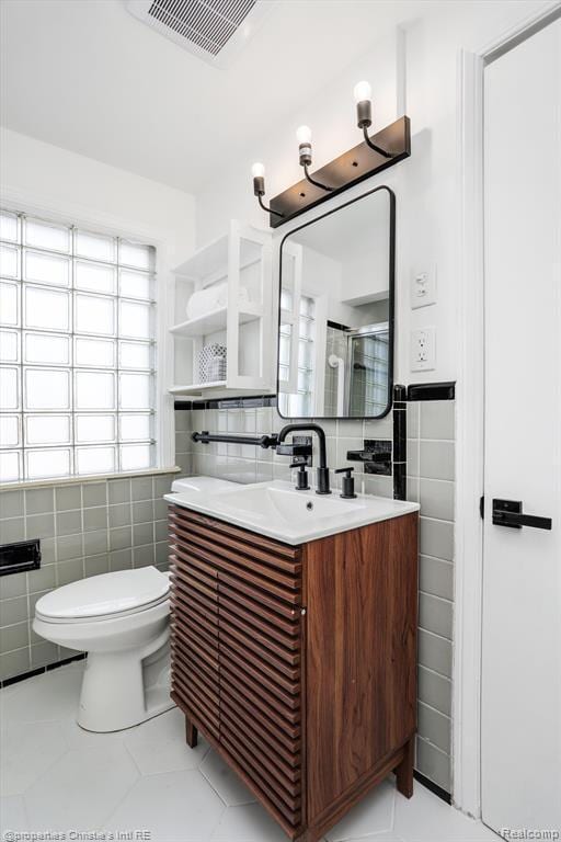 17617 Kentucky St, Detroit, MI 48221 - bathroom with tile walls, tile patterned flooring, vanity, an enclosed shower, and wainscoting