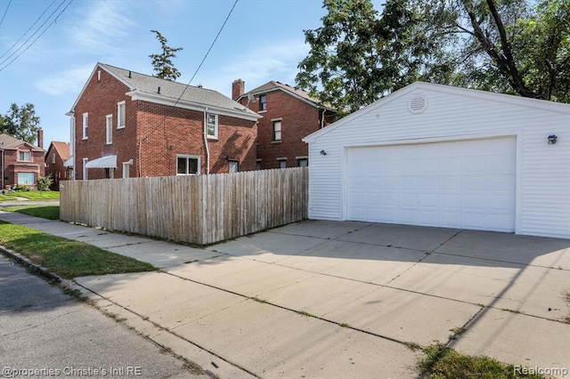 17617 Kentucky St, Detroit, MI 48221 - view of side of home featuring a detached garage, brick siding, and an outbuilding